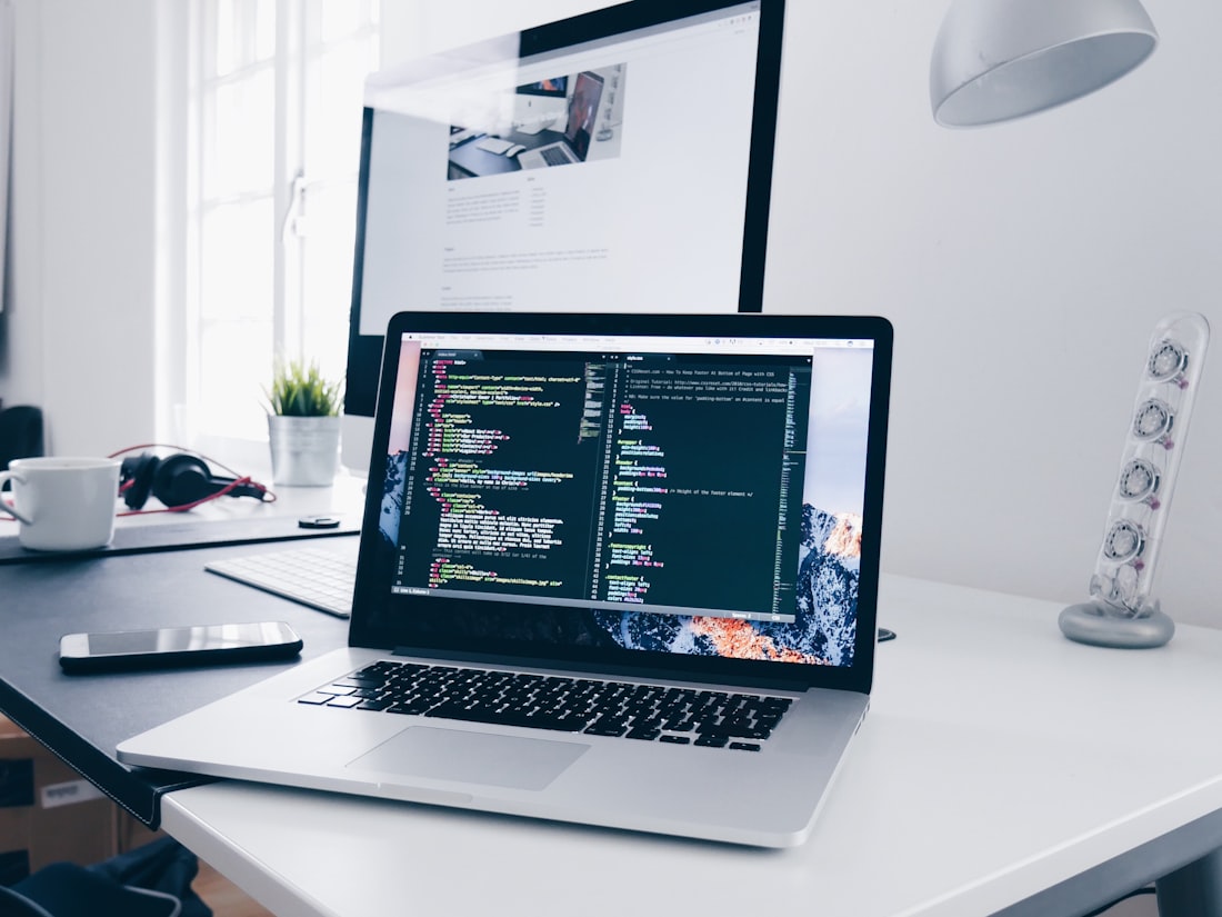 A laptop on a desk showing code — where the work happens.